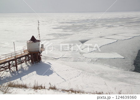 Scenic at the ice-free Angara River flows out of the frozen Lake Baikal. Melted ice floes on blue water. Located Baikal lake. Scenic at the ice-free Angara River flows out of the frozen Lake Baikal. Melted ice floes on blue water. Located Baikal lake. 124639360