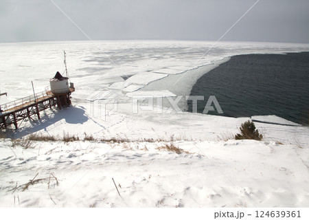 Scenic at the ice-free Angara River flows out of the frozen Lake Baikal. Melted ice floes on blue water.  Located Baikal lake. 124639361