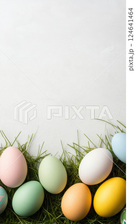 Colorful Easter eggs rest on green grass against white background Colorful Easter eggs rest on green grass against white background 124641464
