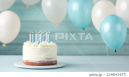 Festive birthday cake with candles and balloons in background Festive birthday cake with candles and balloons in background 124641473