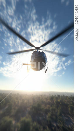 helicopter flies over forested landscape at sunrise 124641480