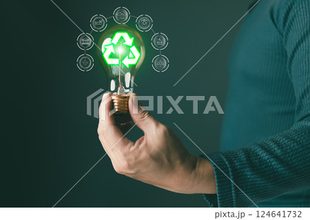 hold lightbulb to sustainability and reduce global warming,climate change,ecology friendly investment,ESG environment social governance,Green Business Innovation and Sustainable Development concept. 124641732
