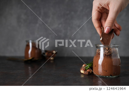 Chocolate mousse in a glass on a dark background. 124641964