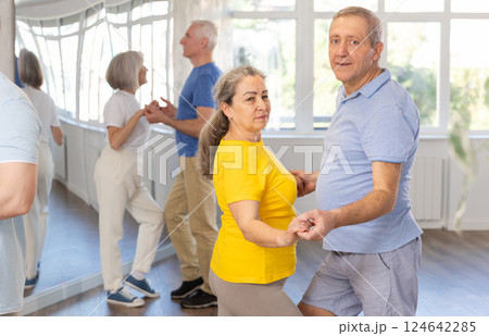Senior woman practicing passionate samba with man in dance class 124642285