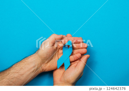 Blue ribbon symbolizes support for cancer awareness and prevention efforts 124642376