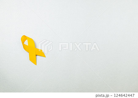 Yellow ribbon symbolizes hope and support for cancer awareness campaign 124642447