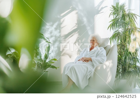 Elderly woman enjoying a moment of calm in a minimalist spa environment Elderly woman enjoying a moment of calm in a minimalist spa environment 124642525