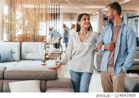 Walking around. Couple choosing the sofa and bed in the store 124643909