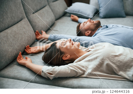 Laying down together. Couple choosing the sofa and bed in the store 124644316