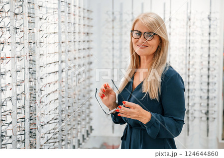 Choosing glasses. Woman is in the store 124644860