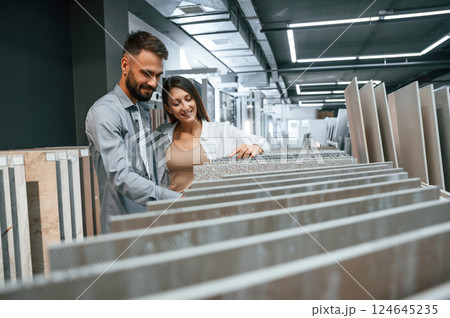 Different materials and colors. Woman and man is in the store of goods for the home Different materials and colors. Woman and man is in the store of goods for the home 124645235