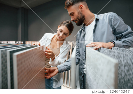 Looking for products. Woman and man is in the store of goods for the home Looking for products. Woman and man is in the store of goods for the home 124645247