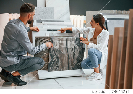 Big choice of products. Woman and man is in the store of goods for the home Big choice of products. Woman and man is in the store of goods for the home 124645256
