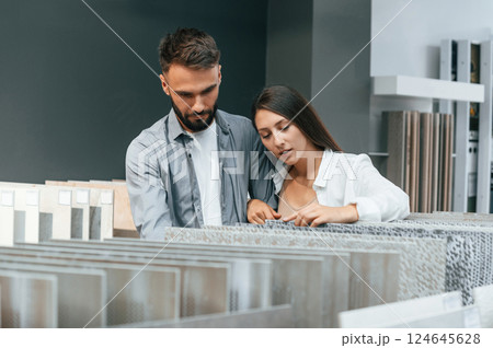Indoors together. Woman and man is in the store of goods for the home Indoors together. Woman and man is in the store of goods for the home 124645628