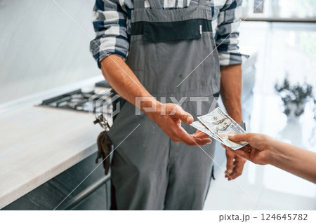 Payment for the work. Close up view. Plumber receiving cash 124645782
