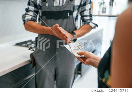 Payment for the work. Close up view. Plumber receiving cash 124645783