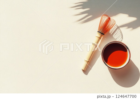 Matcha tea preparation with whisk on a minimalist beige surface showcasing cultural elegance 124647700