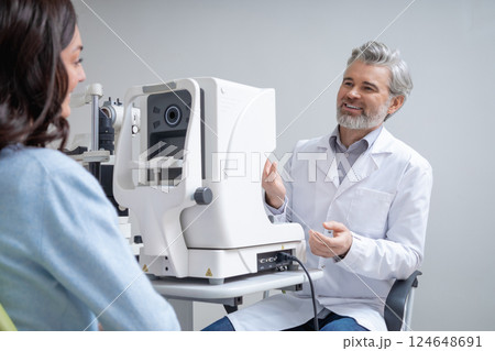 Woman visiting optical clinic for eyesight test with ophthalmologist 124648691