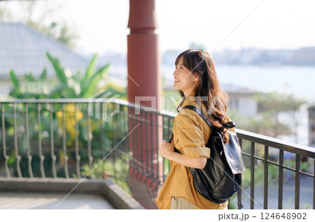 Traveler, Embrace the thrill of solo travel with a joyful Asian woman in her 30s. Exploring the cultural treasures of Bangkok, she radiates wanderlust and the spirit of independent discovery. Traveler, Embrace the thrill of solo travel with a joyful Asian woman in her 30s. Exploring the cultural treasures of Bangkok, she radiates wanderlust and the spirit of independent discovery. 124648902