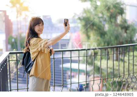 Traveler young asian woman in her 30s navigates the vibrant streets of Bangkok. Let this photo inspire your own journey. 124648905