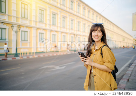 Traveler asian woman in her 30s using smartphone for navigation destination on the urban street at Bangkok, Thailand. 124648950