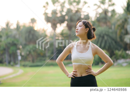 sportswoman with white sportswear in public park. sportswoman with white sportswear in public park. 124648986