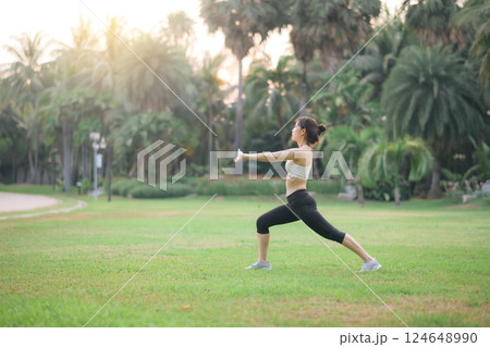 Female runner. Fit young Asian woman with sportswear stretching muscle in park before running and enjoying healthy outdoor. Fitness runner girl in public park. Wellness being concept Female runner. Fit young Asian woman with sportswear stretching muscle in park before running and enjoying healthy outdoor. Fitness runner girl in public park. Wellness being concept 124648990