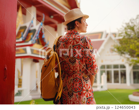 Woman Exploring Colorful Streets Near Buddhist Temples in Bangkok Woman Exploring Colorful Streets Near Buddhist Temples in Bangkok 124650043