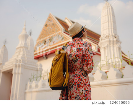 Woman Exploring Colorful Streets Near Buddhist Temples in Bangkok 124650096