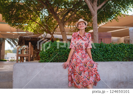 Young female tourist exploring iconic landmarks of the United Arab Emirates. Young female tourist exploring iconic landmarks of the United Arab Emirates. 124650101