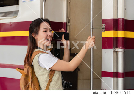 Joy and Adventure. A traveler stands at the train door, ready to embark on her journey. 124651516