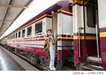 Travel Excitement and Departure. A cheerful woman waving goodbye from the train, embracing her travel journey. 124651564