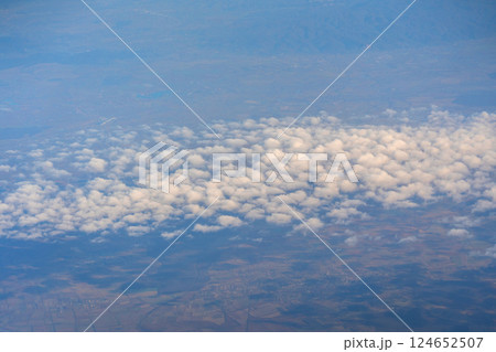 Blue sky with white clouds, flying above cloudy sky texture pattern, cloudscape blurred light 124652507