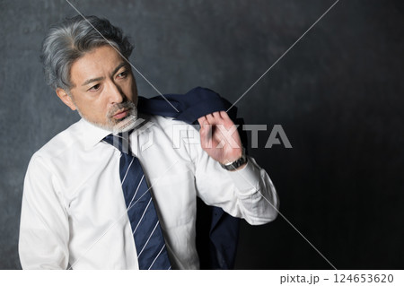 ジャケットを羽織るグレイヘアのビジネスマン　エグゼクティブな転職やスタート 124653620