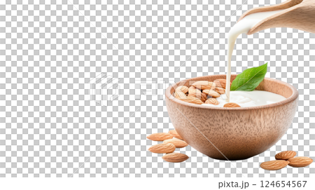 Healthy Organic Almonds Poured into Wooden Bowl with Milk Pouring Over Them 124654567