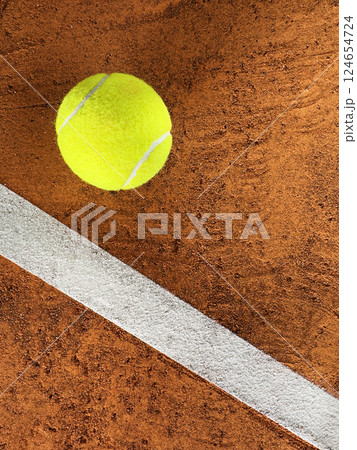Tennis Ball on a Clay Court, Top Down View Tennis Ball on a Clay Court, Top Down View 124654724