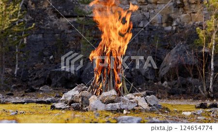 Beautiful Crackling Campfire in a Rocky Landscape , Sunrise , Authentic Place 124654774