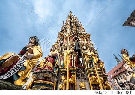 Nuremberg, Germany, August 1, 2023. Iconic shot of the magnificent fountain in the market square. Details of the fountain's many golden statues. Travel destinations. 124655481