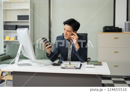 Mature stressed Asian businessman working in the office. Businessman thinking too much work concept in the office. Mature stressed Asian businessman working in the office. Businessman thinking too much work concept in the office. 124655510