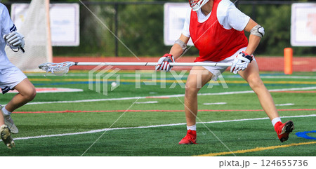 Lacrosse Players in Action on a Field 124655736
