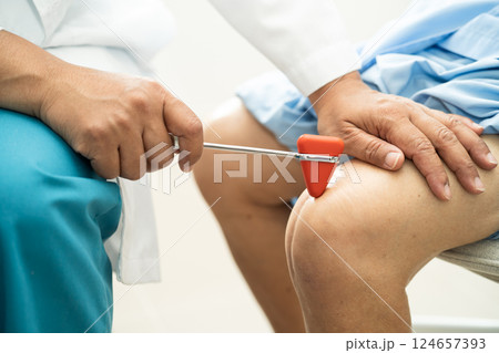 Asian doctor physiotherapist examining, massaging and treatment knee and leg of senior patient in orthopedist medical clinic nurse hospital. 124657393
