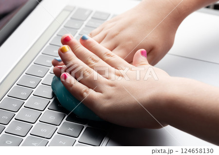 Hands cleaning keyboard with slime 124658130