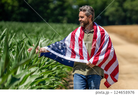 4th of July. American labor day. American flag and man farmer. Flag of USA. Independence day. Man in field. Man with American flag in crop field. Independence day of America. Harvesting and farming 124658976