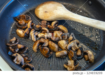 Fried in vegetable oil champignons in a frying pan Fried in vegetable oil champignons in a frying pan 124659209