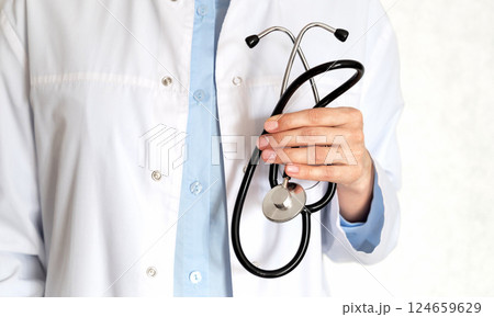 Healthcare professional taking notes in a clinical setting during a routine check-up Healthcare professional taking notes in a clinical setting during a routine check-up 124659629