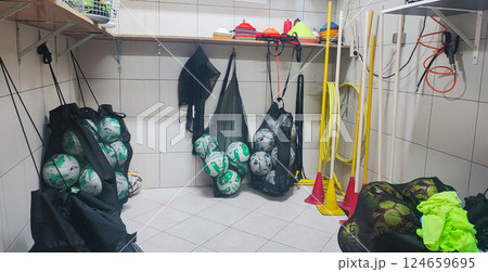 Many different sports equipment in room with beige walls. Concept of youth sports, soccer schools for children. Many different sports equipment in room with beige walls. Concept of youth sports, soccer schools for children. 124659695
