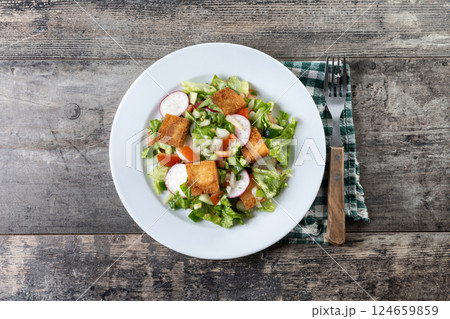 Fattoush salad, Traditional Lebanese Salad on wooden table Fattoush salad, Traditional Lebanese Salad on wooden table 124659859