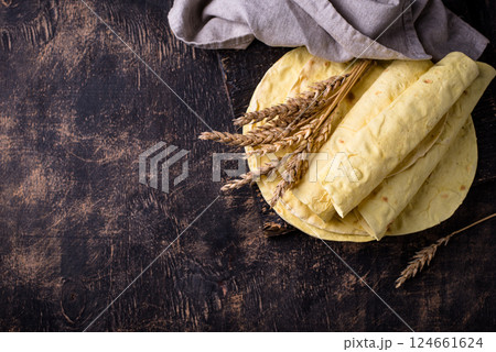 Lavash flat bread on green background 124661624