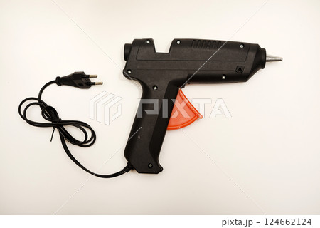 Black glue gun on a white background. Black glue gun on a white background. 124662124