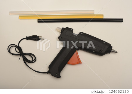 Black glue gun on a white background. Black glue gun on a white background. 124662130